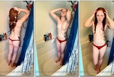 Kelly Kat, uma jovem ruiva se despindo enquanto toma banho